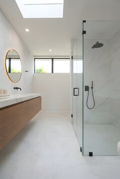 Spacious luxury master bathroom design showcasing a freestanding double floating vanity counter next to a glass walk in shower room