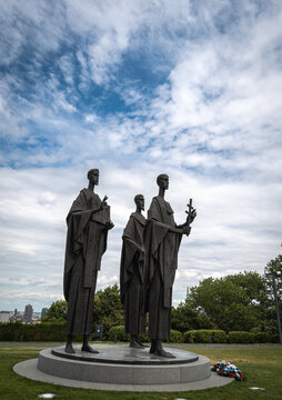 Bratislava, Slovakia - July 10,2025. Vertical side view  photo of the bronze statues of the three Saints Cyril, Methodius and Gorazd in the castle of the old town