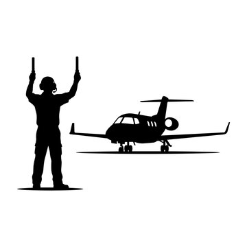 Airport ground marshaller guiding private jet on runway