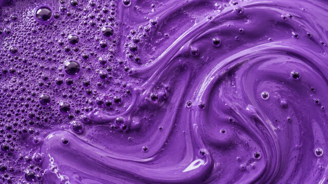 Vibrant purple ube paste or batter swirled with fine bubbles in a smooth glossy texture