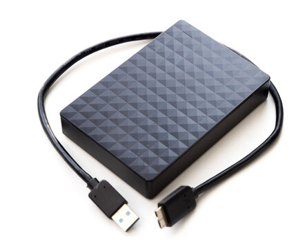 Black external hard drive with USB cable on white background