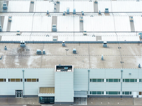 Aerial view of a modern beef production plant with large industrial rooftops and ventilation units in Poland.