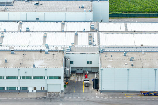 Aerial view of a modern beef production plant with industrial rooftops, ventilation units, and a loading bay area in Poland.