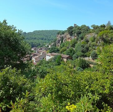 overview of the cliff of Cotignac and roofs of the old village gathered under it. Cotignac, in southern France is reknown for its trogloditic houses and ancient village inhabitaded for ages. 