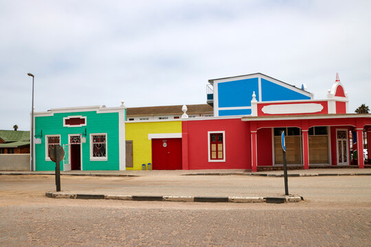 Zwei farbige H&auml;userfassaden mit dekorativen Elementen stehen an einer Stra&szlig;e in Swakopmund in der Region Erongo, Namibia.