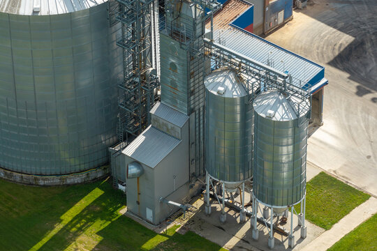 Aerial view of production scale storage silo system with metal tanks and industrial infrastructure in Poland.