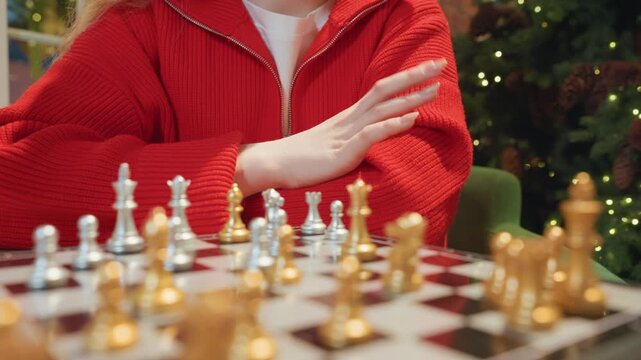 Contemplative cafe chess endgame caucasian thinker, hands poised over gold and silver pieces, quiet tension and careful planning, warm lights and festive bokeh create thoughtful mood