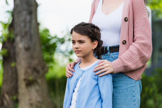 Cherished moments of a mother and daughter in a sunlit garden
