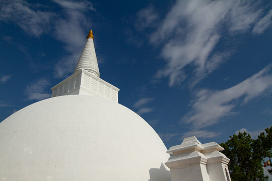 White Buddhist Stupa Dome Against Blue Sky in Sri Lanka