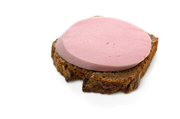 Delicious slice of pink bologna on hearty brown bread ready to be enjoyed for a snack or light meal © Михаил Шорохов