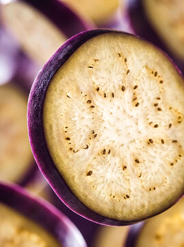 Extreme Macro Backlit Eggplant Slice with Glowing Seed Texture