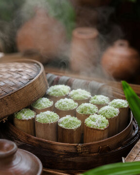 Kue putu steaming in bamboo tubes
