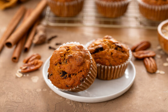 Pumpkin muffins with pecans and dried cranberries on a plate