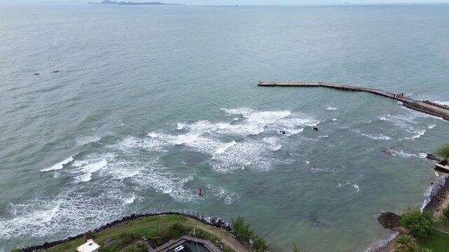 Scenic drone flight over Anyer Beach featuring gentle waves and a tropical shoreline in Banten, Indonesia.