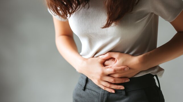 Woman with stomach ache holding abdomen
