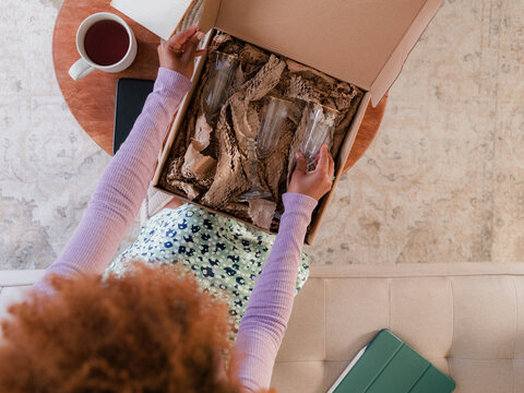 Woman checking parcel after delivery 