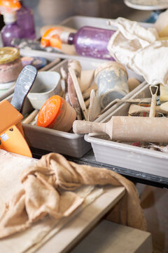 Box of clay modeling tools and equipment in a pottery workshop
