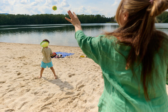 Mother and Child Playing Catch on the Beach