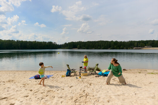 Family Playing Paddle Ball on the Beach