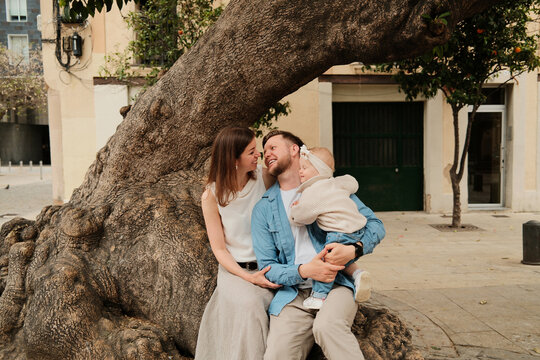 Outdoors at the nature portrait of parents in love and their child 