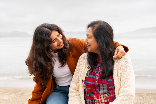 Mother and Daughter Share Time by the Beach