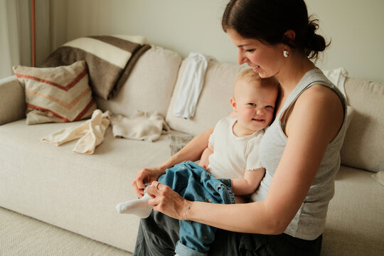 Portrait of mother getting ready with her happy child at home 