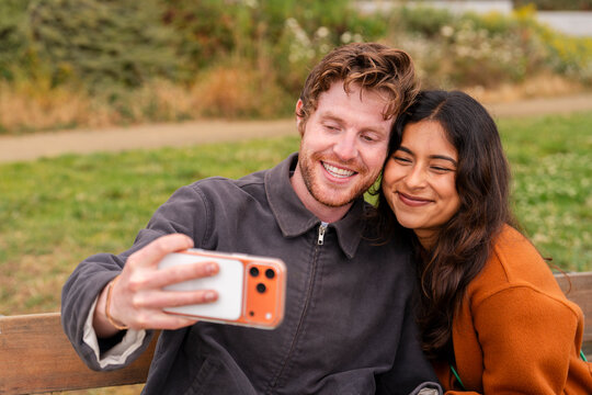 couple using cellphone together 