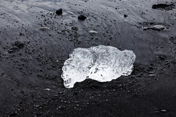 Crystalline Glacial Ice on Volcanic Black Sand © MarekLuthardt
