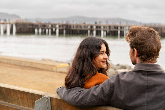 couple talking on bench candid moment