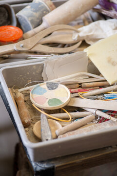 Box of clay modeling tools and equipment in a pottery workshop