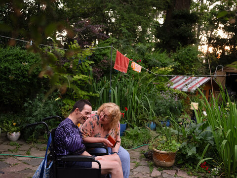 Mother and Son laughing in a garden