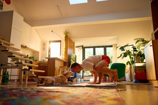 Man practices yoga in the morning