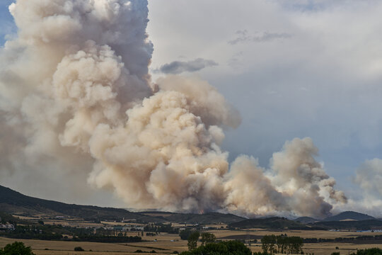 Massive Wildfire Smoke Plume Over Rural Landscape