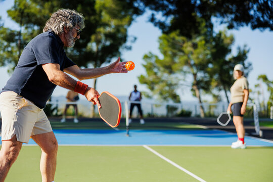 Senior enjoying pickleball game on outdoor court