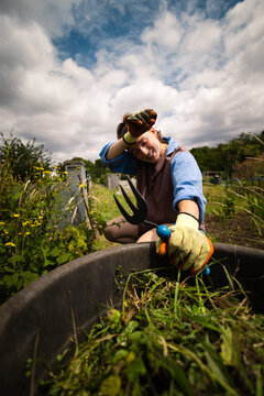 Exhausted woman wiping sweat while gardening