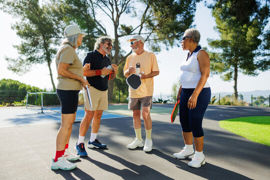 Senior friends enjoying social game of pickleball daily