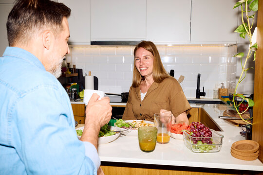 Friends Enjoy Lunch Together in a Modern Kitchen