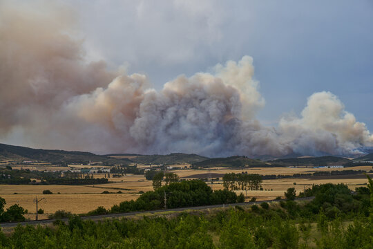 Massive Wildfire Smoke Plume Over Rural Landscape