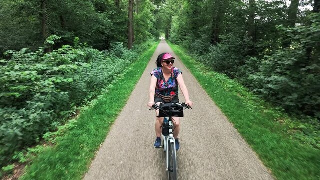 Woman cycling through Dutch countryside
