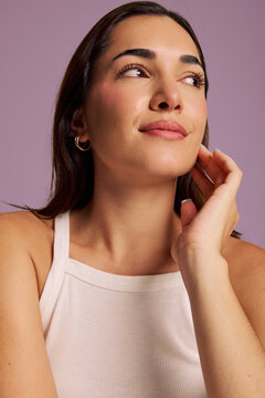 A Woman is Smiling Slightly While Looking to the Side