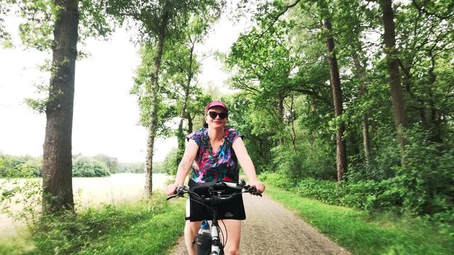 Woman cycling through Dutch countryside
