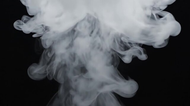 Thick white smoke billowing upward and expanding against a solid black background for overlays
