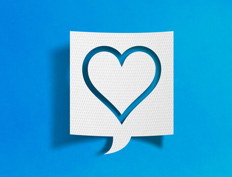 Heart outline speech bubble on blue background with paper cutout design