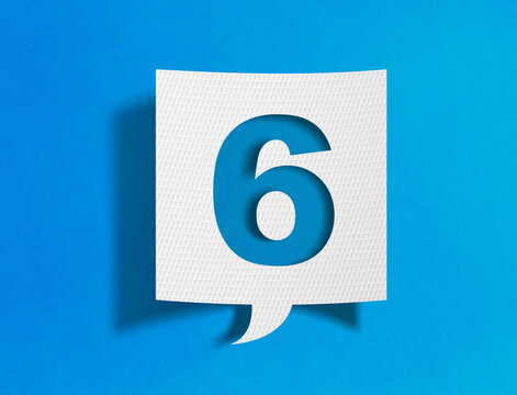 Number six speech bubble on blue background with paper cutout design