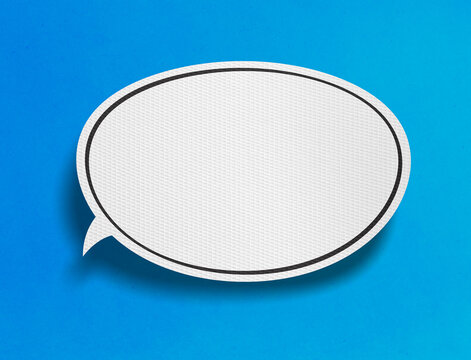 Blank speech bubble on blue background with paper cutout design
