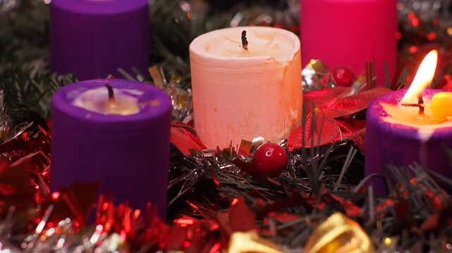 Advent wreath next to nativity scene with holy family. Catholic tradition symbolising the four weeks of Advent. A time of waiting and prayer.