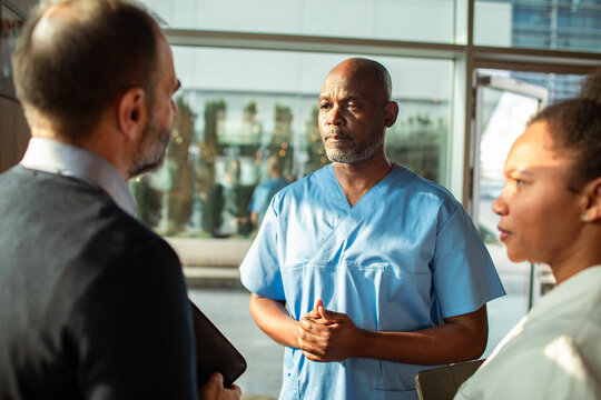 Healthcare professionals discussing patient care in hospital lobby