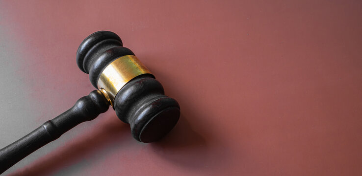 Wooden judge gavel lying on brown background, court justice and legal authority concept