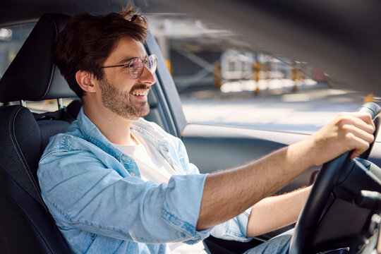 Smiling driver with eyewear enjoying a test drive
