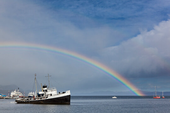 South America, Argentina, Tierra del Fuego, Ushuaia, Beagle Channel, Wreck Saint Christopher on sea rainbow in background